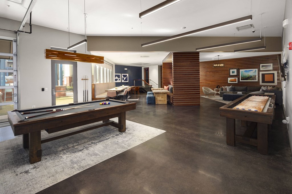 a large living room with a pool table and other furniture