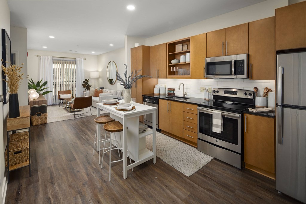 a kitchen and dining room with wooden cabinets and stainless steel appliances