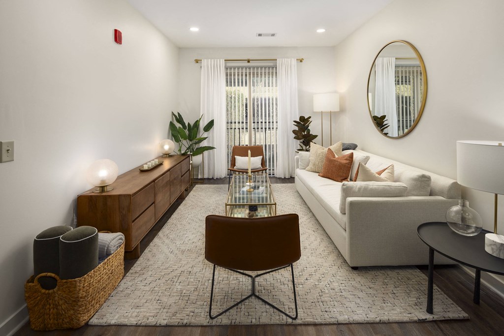 a living room with white furniture and a glass table