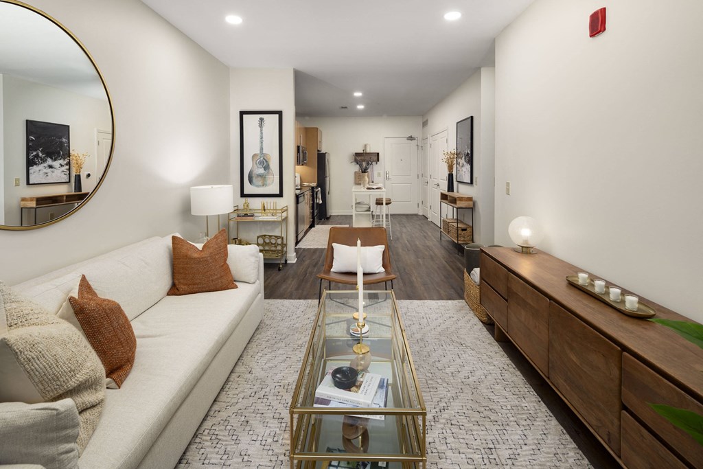 a living room with a white couch and a glass coffee table