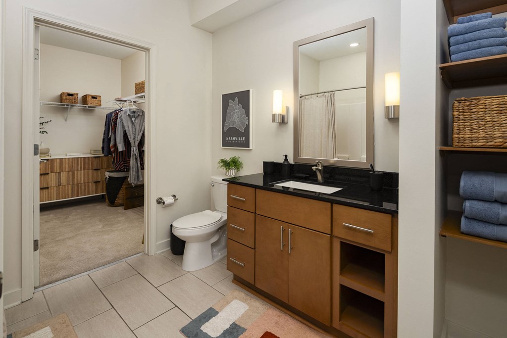a bathroom with a toilet and a sink and a mirror