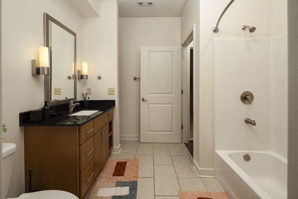 a bathroom with a large shower and a sink and a toilet