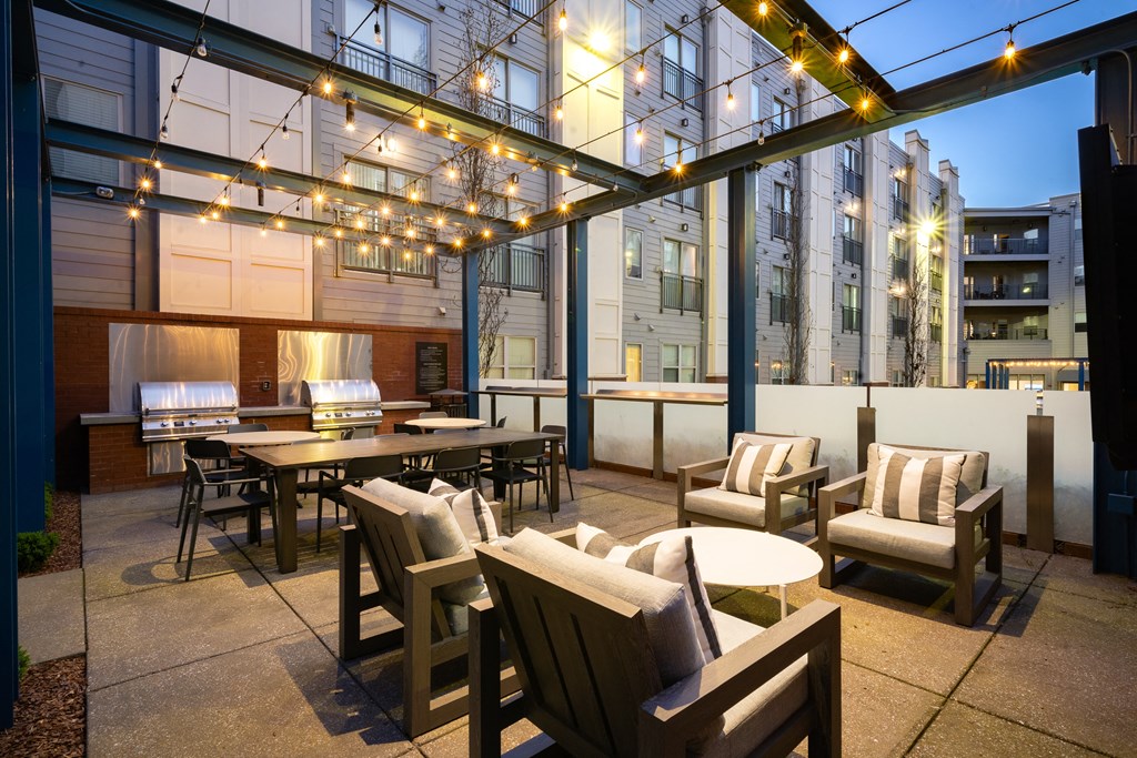 a rendering of a patio with chairs and tables and lights