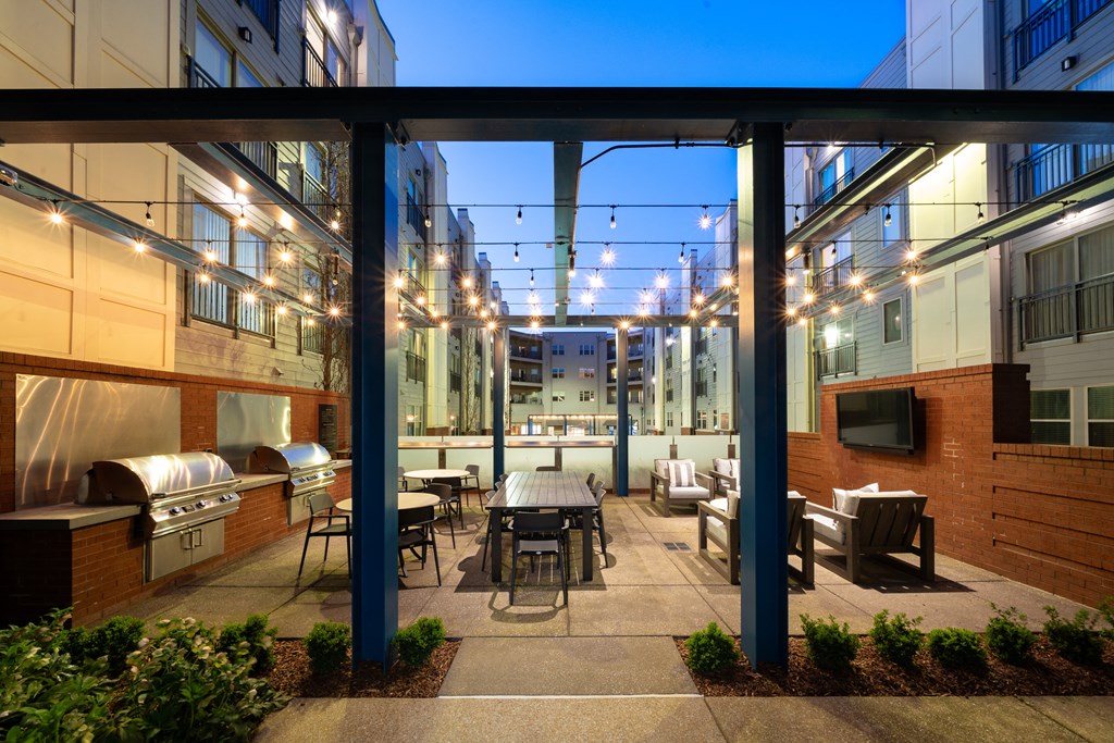 a patio with a table and chairs in a courtyard