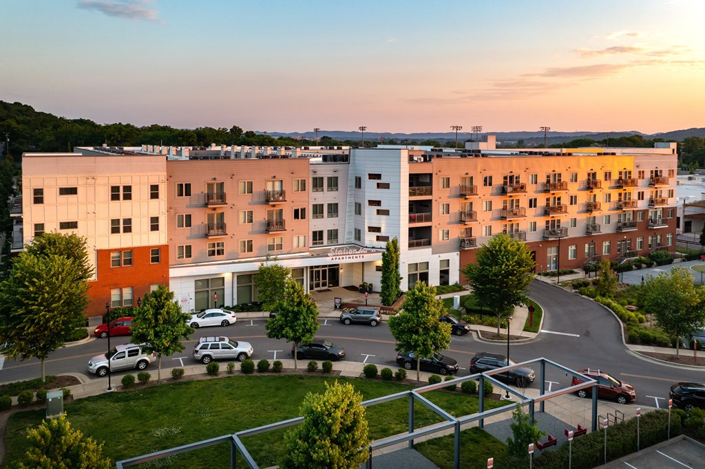 an aerial view of an apartment building at sunset