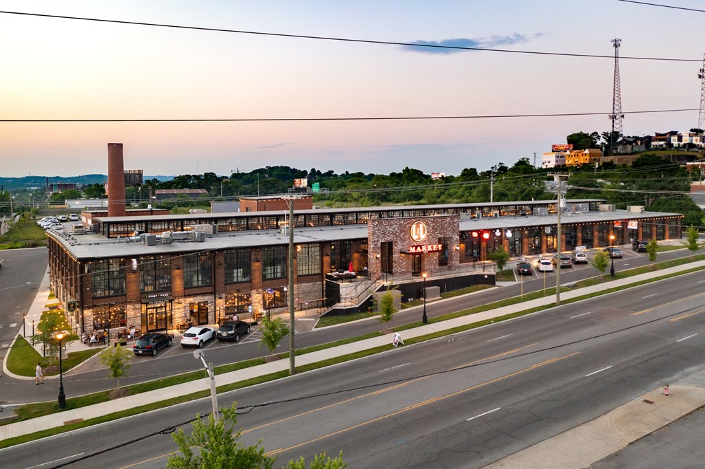 an aerial view of a building on the side of a street