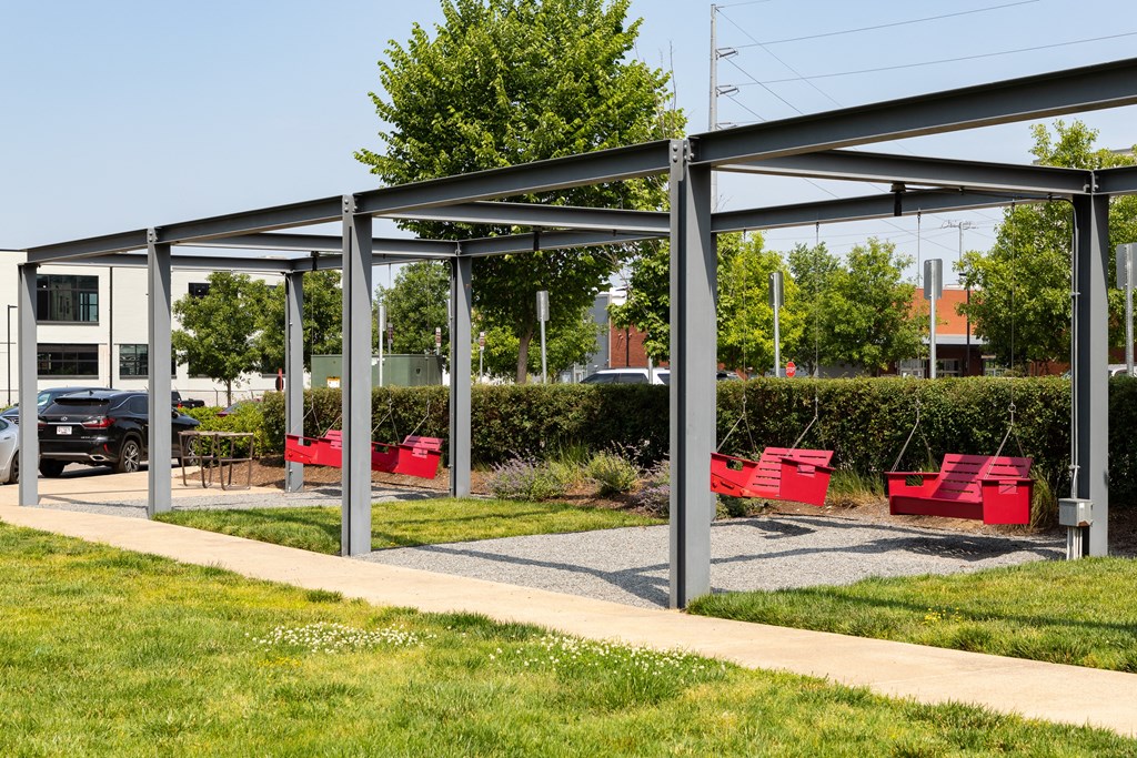 a group of red benches in a park