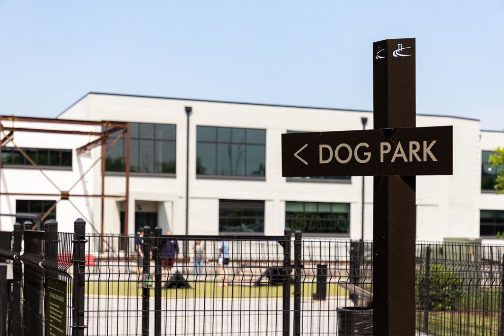 a dog park sign in front of a building