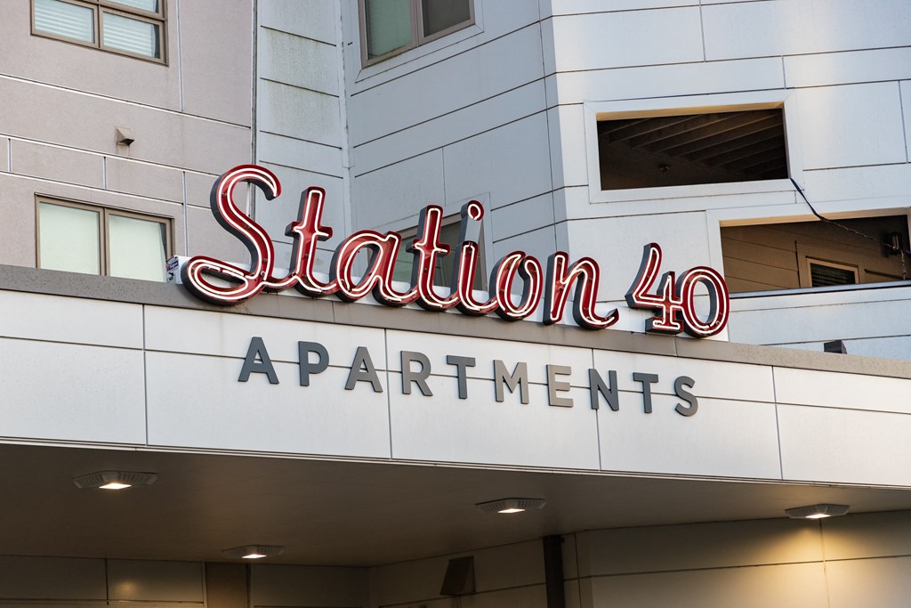 a sign for station 40 apartments on the side of a building