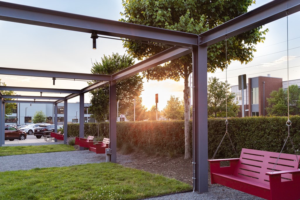 a park with benches and grass and a tree