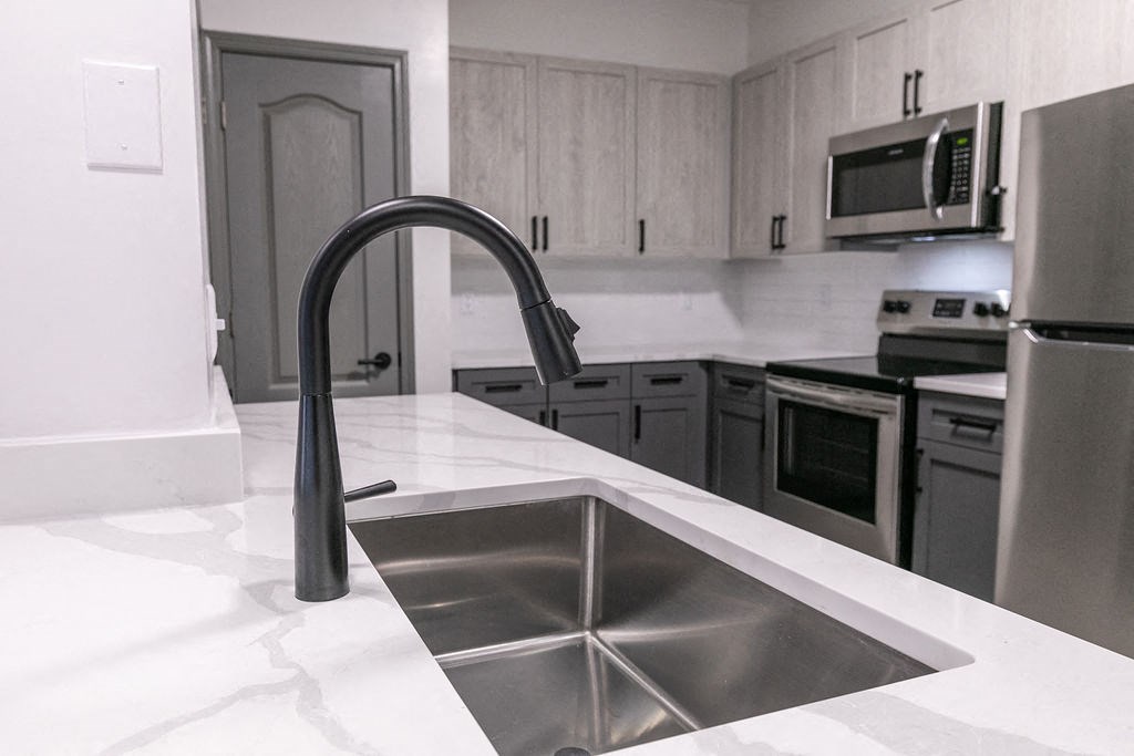 Renovated kitchen close up of matte black gooseneck faucet