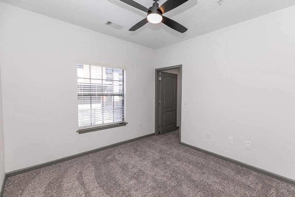 Renovated Bedroom with new carpet and ceiling fan