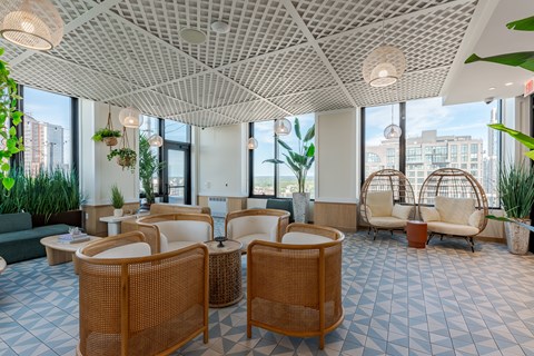 A spacious waiting area with wicker chairs and tables.