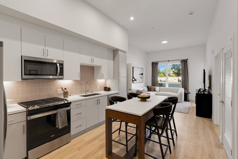 A modern kitchen with a dining table and chairs.