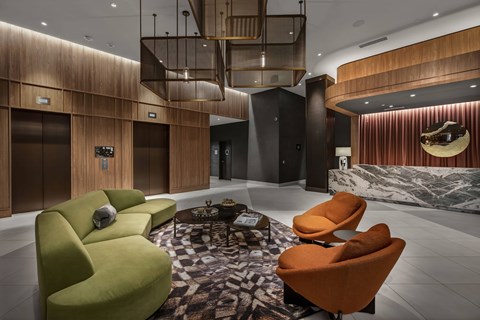 A modern living room with a green and orange sofa.