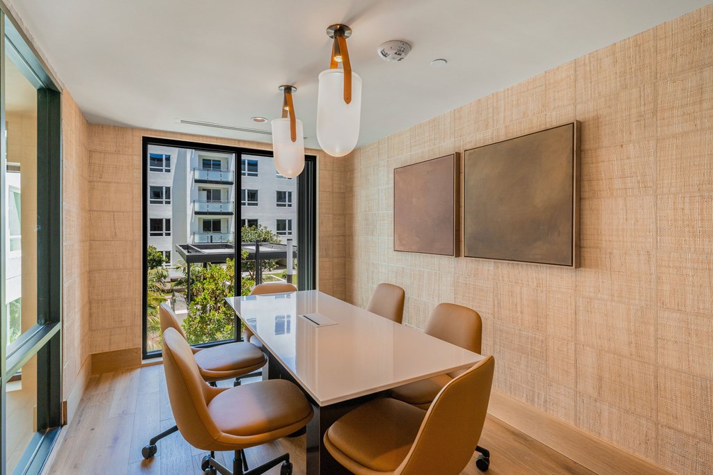 A conference room with a long table and chairs.