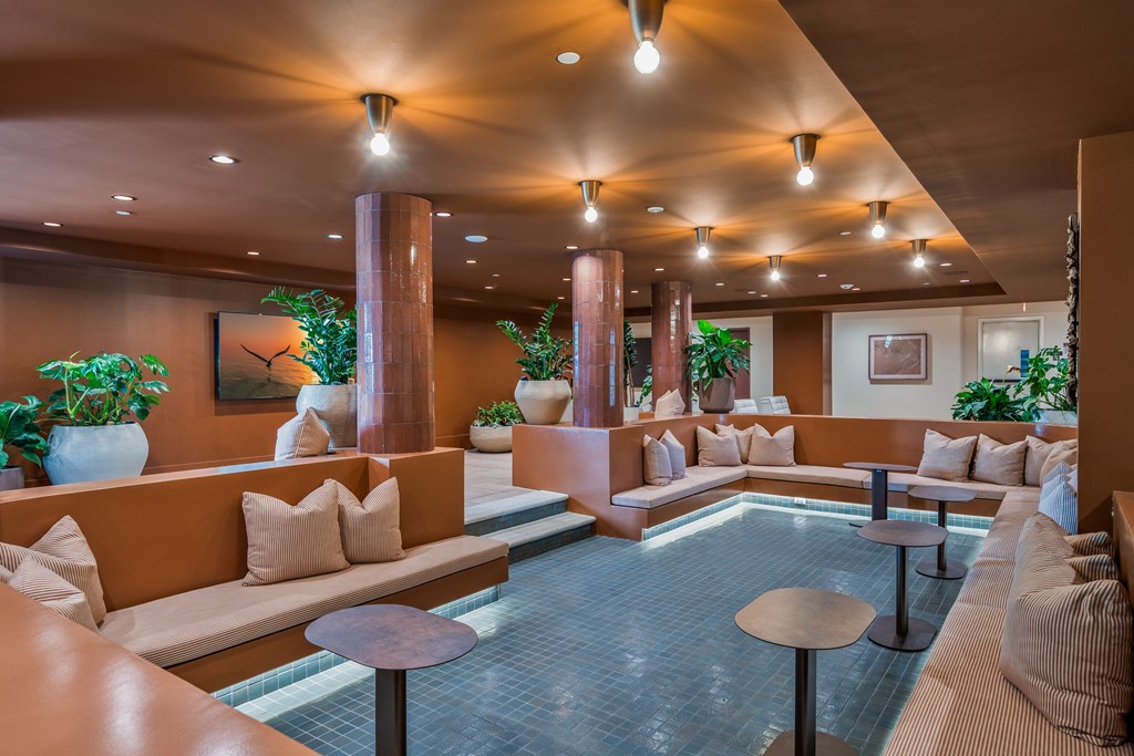 A large room with a pool table and couches.