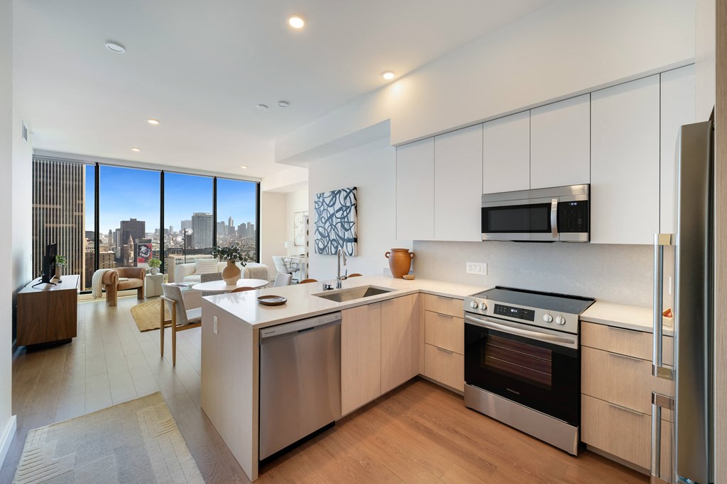 an open kitchen and living room with a city view