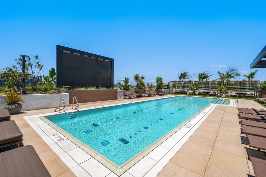 A large screen is mounted above a swimming pool.