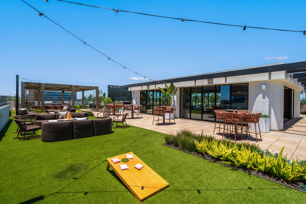 A backyard with a lawn and a table and chairs set up.