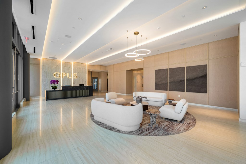 a lobby with couches and chairs and a reception desk