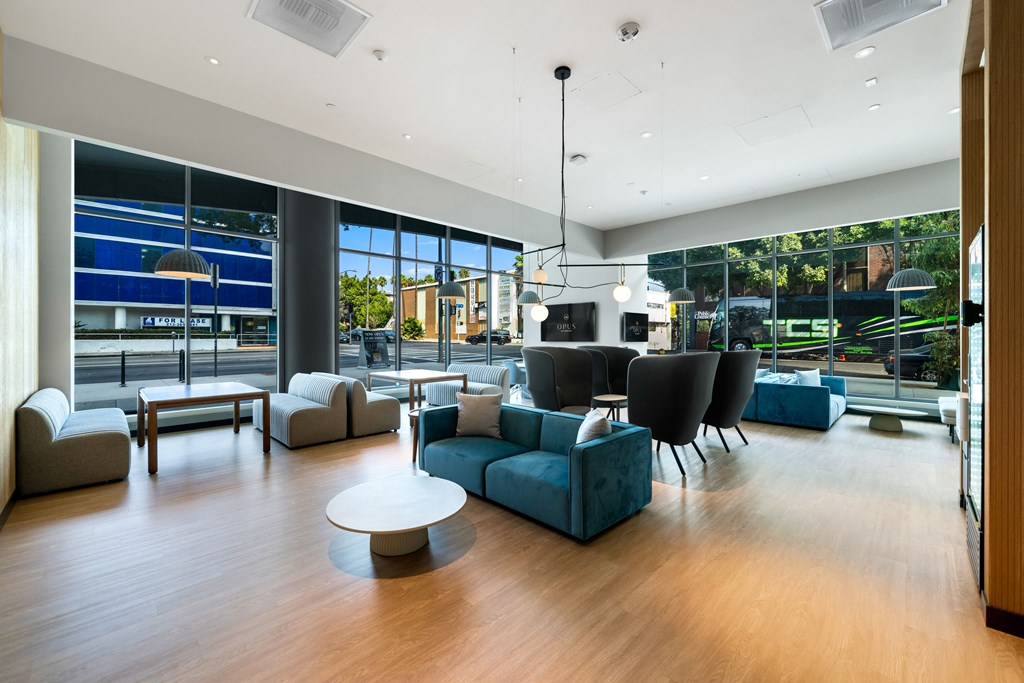 a living room with blue couches and chairs and a table