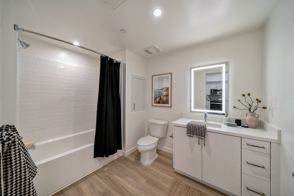 A bathroom with a toilet, sink, and bathtub.