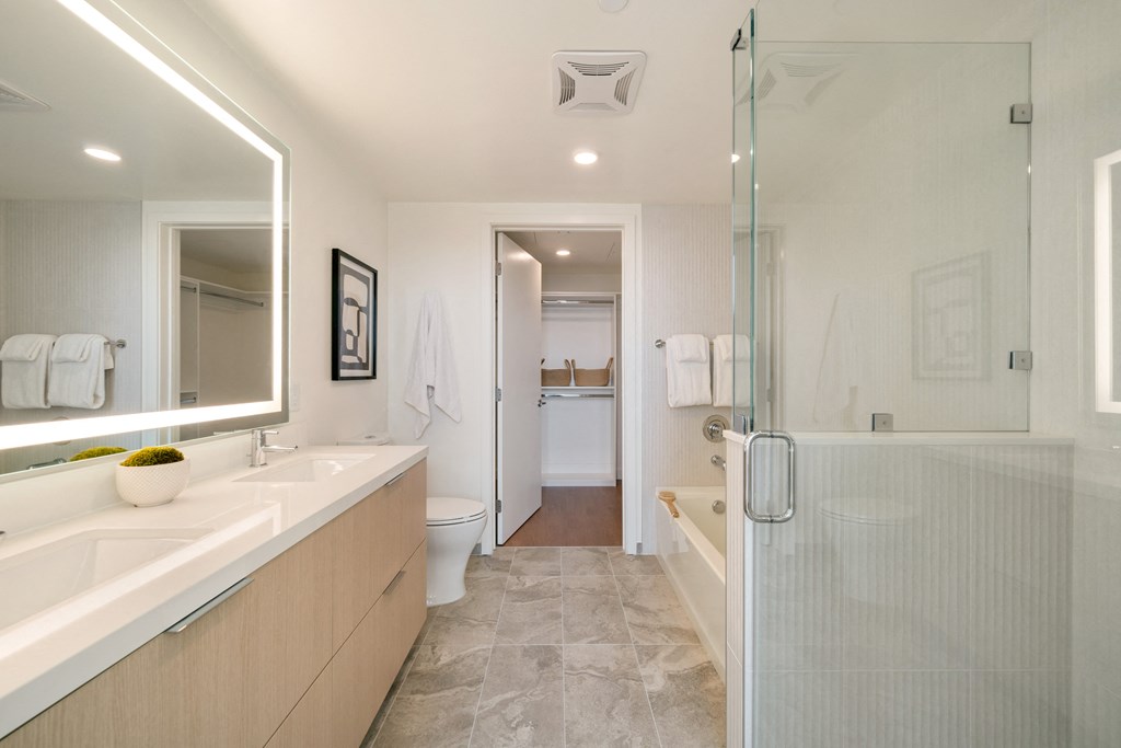 a bathroom with a sink and a shower and a toilet