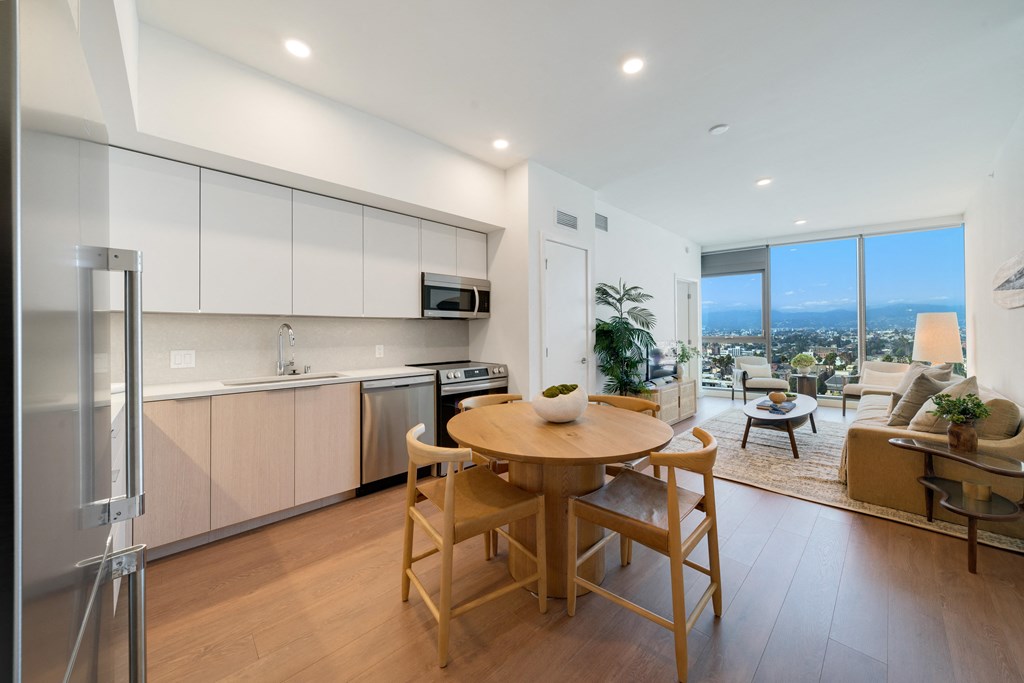 a kitchen and dining area with a table and chairs