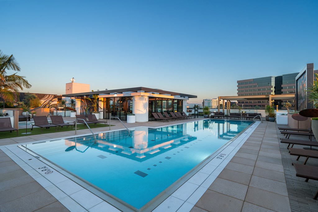 A large swimming pool with a building in the background.