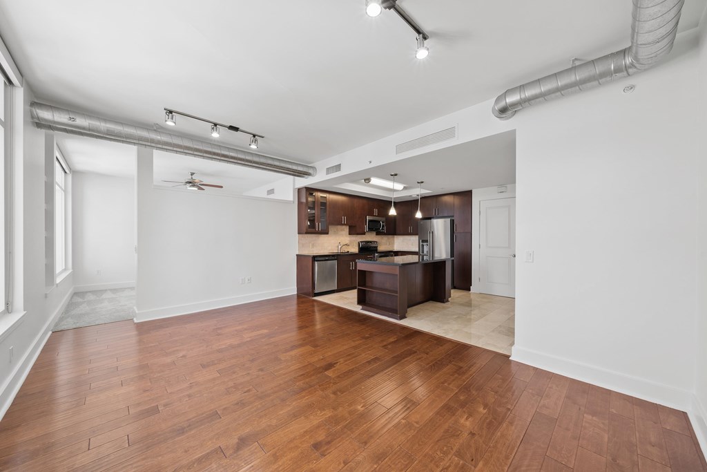 A kitchen with a wooden floor and white walls.