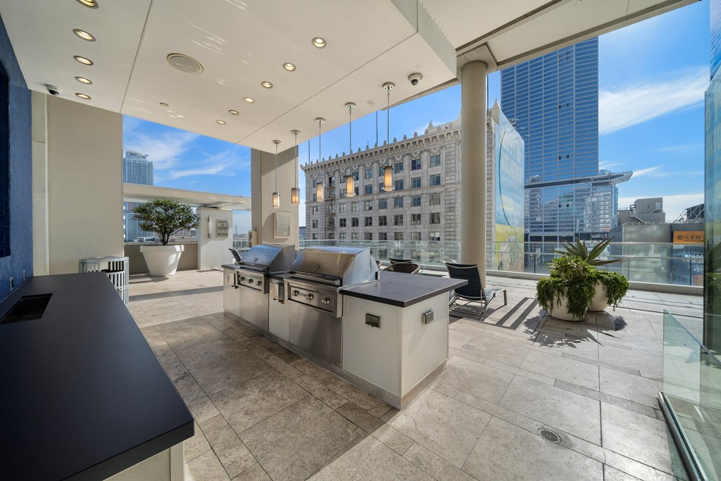 A modern kitchen with a view of the cityscape outside the window.