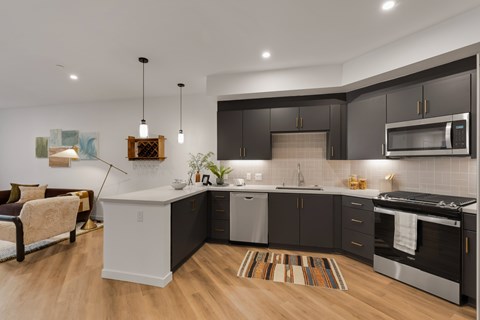 A modern kitchen with dark brown cabinets and a white island.