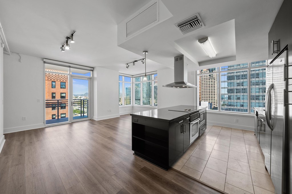 A modern kitchen with a large island and stainless steel appliances.