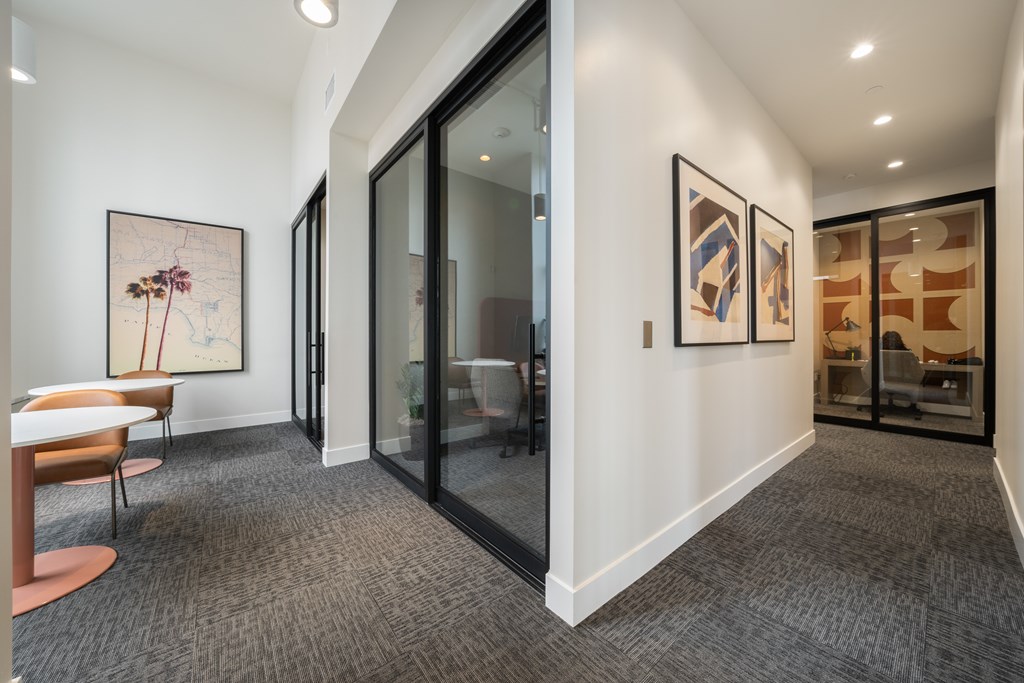 A room with a carpeted floor and a chair.