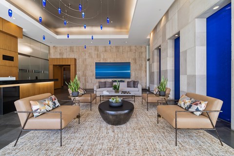 A modern living room with a large rug and a coffee table.