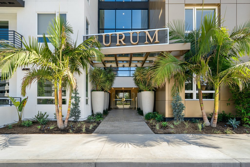 The entrance to a building with the name "URUM" on top of it.