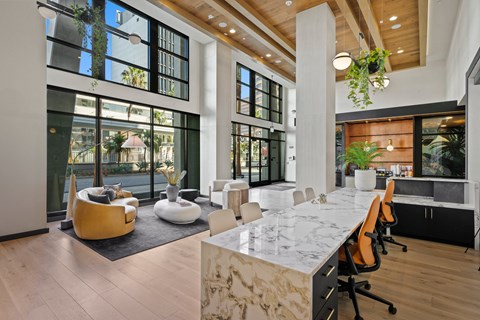 a large conference room with large windows and a marble table and chairs