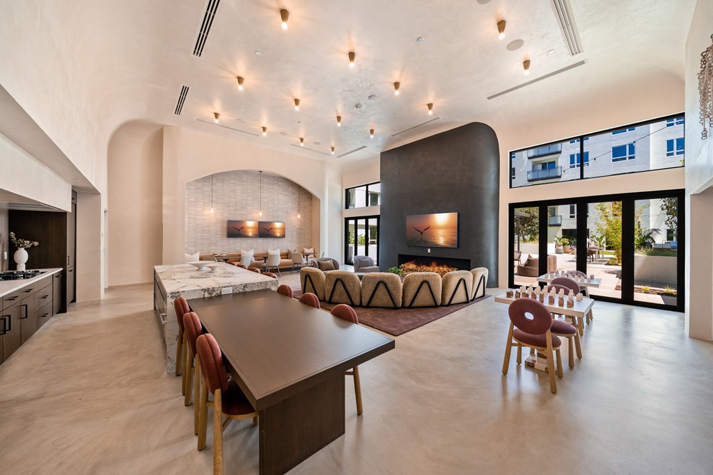 A modern dining room with a long table and chairs.
