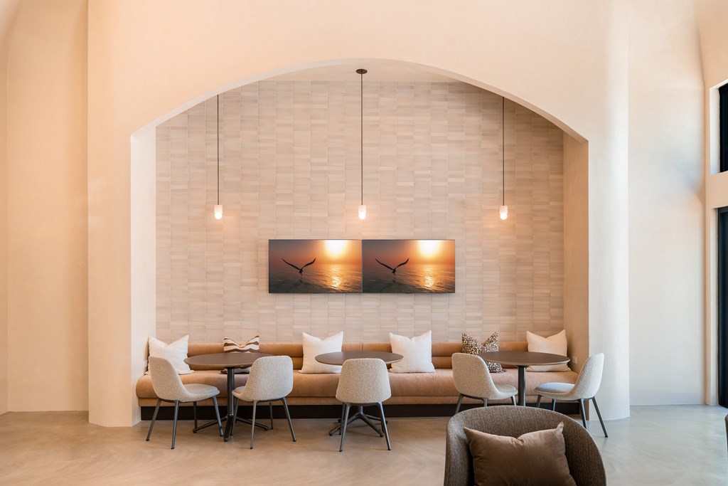 A modern dining area with a long table and chairs.
