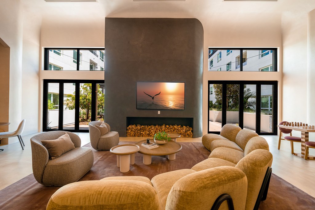 A living room with a fireplace and a row of chairs.