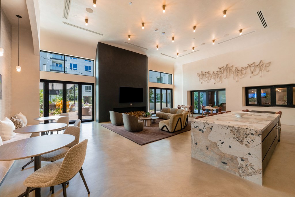 A modern living room with a stone countertop and a large flat-screen TV.
