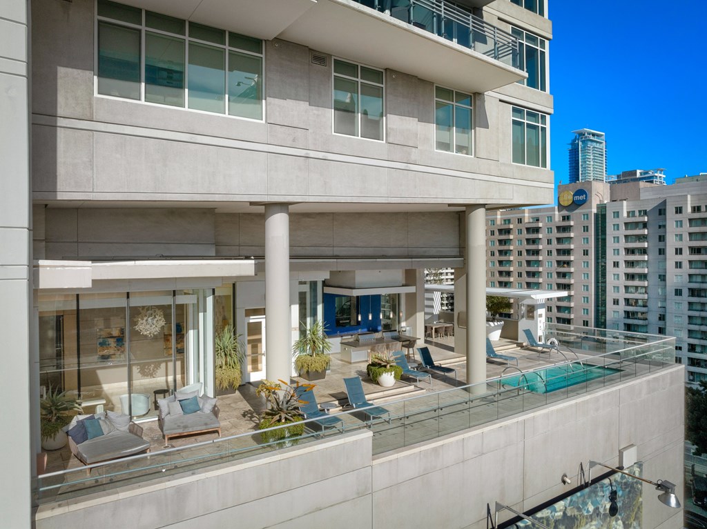 A modern building with a pool on the roof.