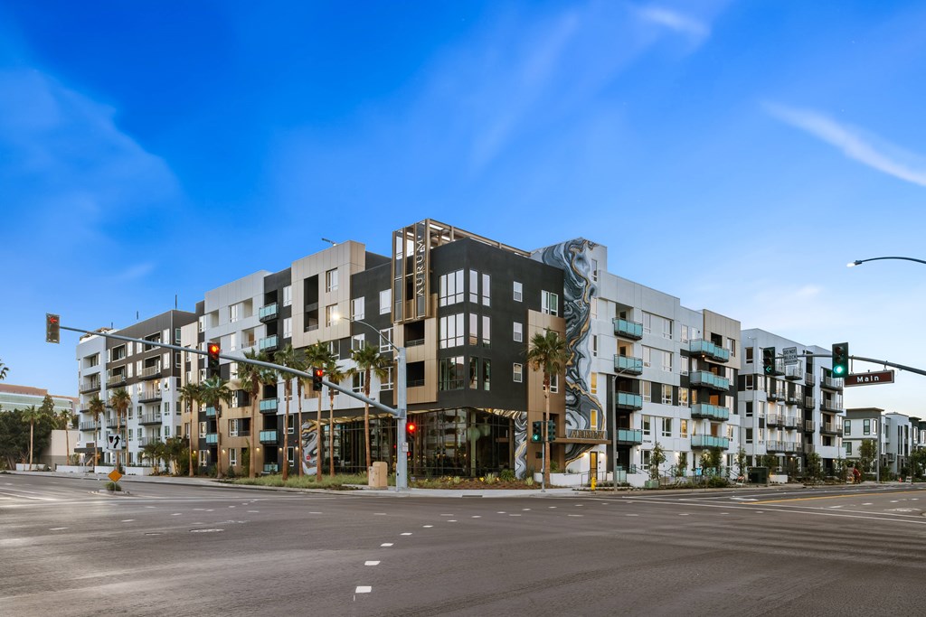 A modern multi-story building with a mix of white and darker colored panels.