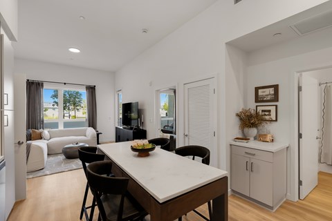 A modern dining room with a large table and chairs.