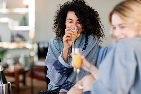 Two women enjoying a drink together in a casual setting.