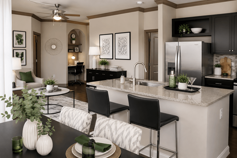 A modern kitchen with a dining table set for two.