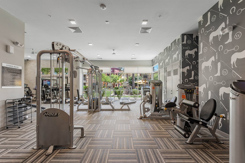 a spacious fitness center with treadmills and other exercise equipment