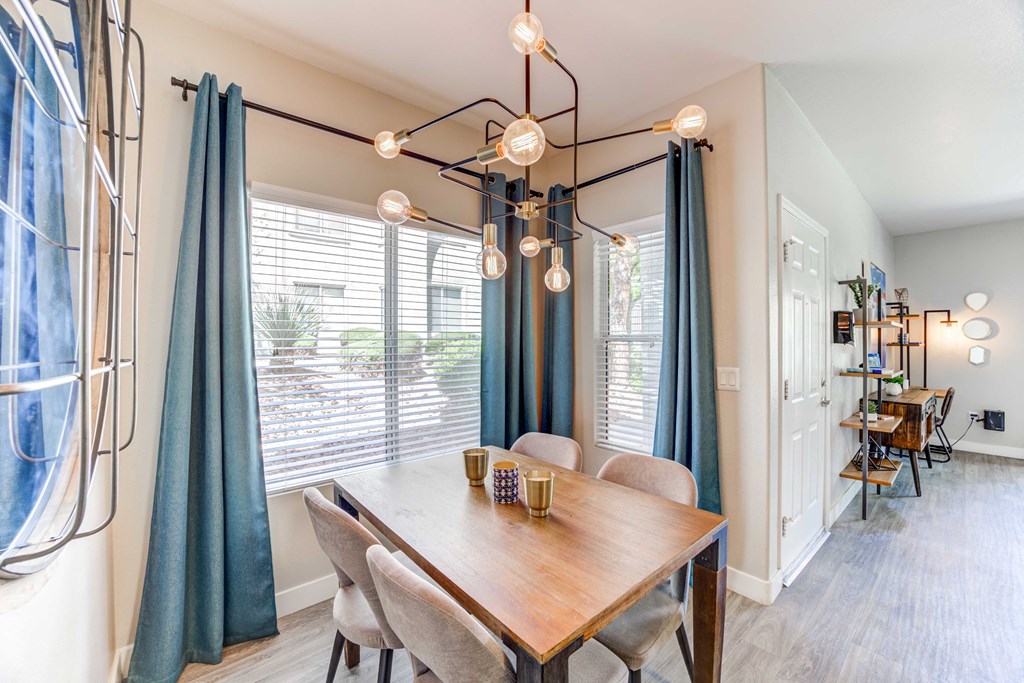 a dining room with a table and chairs and a chandelier