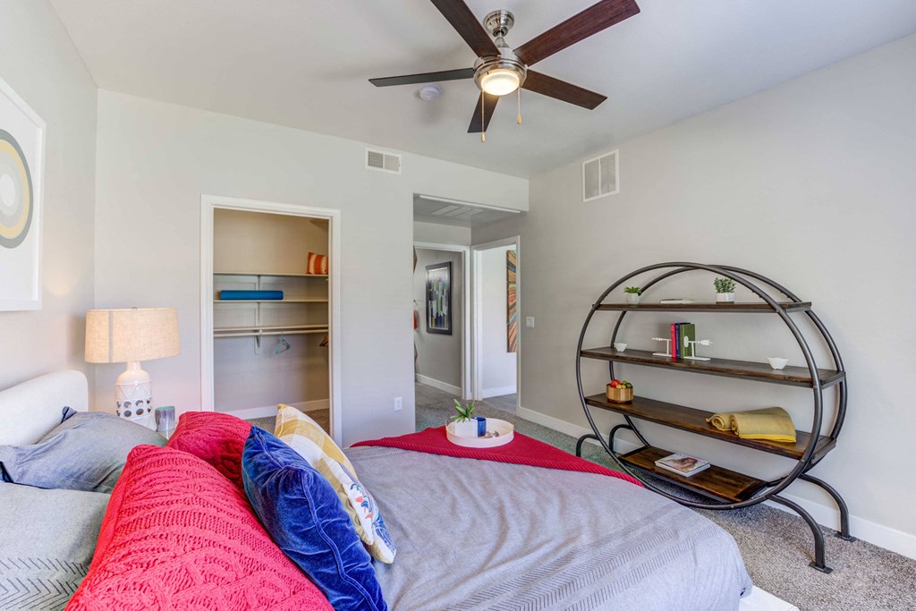 a bedroom with a bed and a ceiling fan